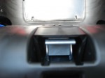 Harness adjuster mechanism with plastic cover