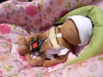 Preemie doll with head hugger insert
