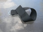 Tether connector strap threaded thru loop on end