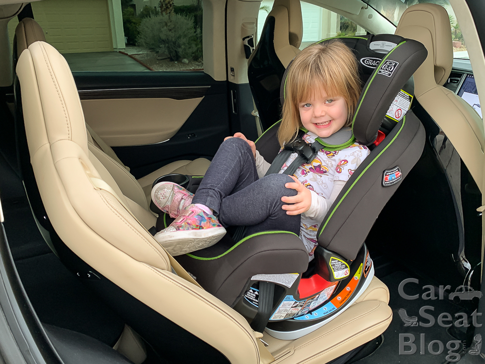 How long should a child face backwards in a car clearance seat